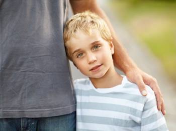 kid hugging his father